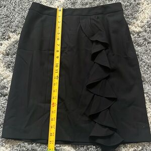 Black skirt with front ruffle.
